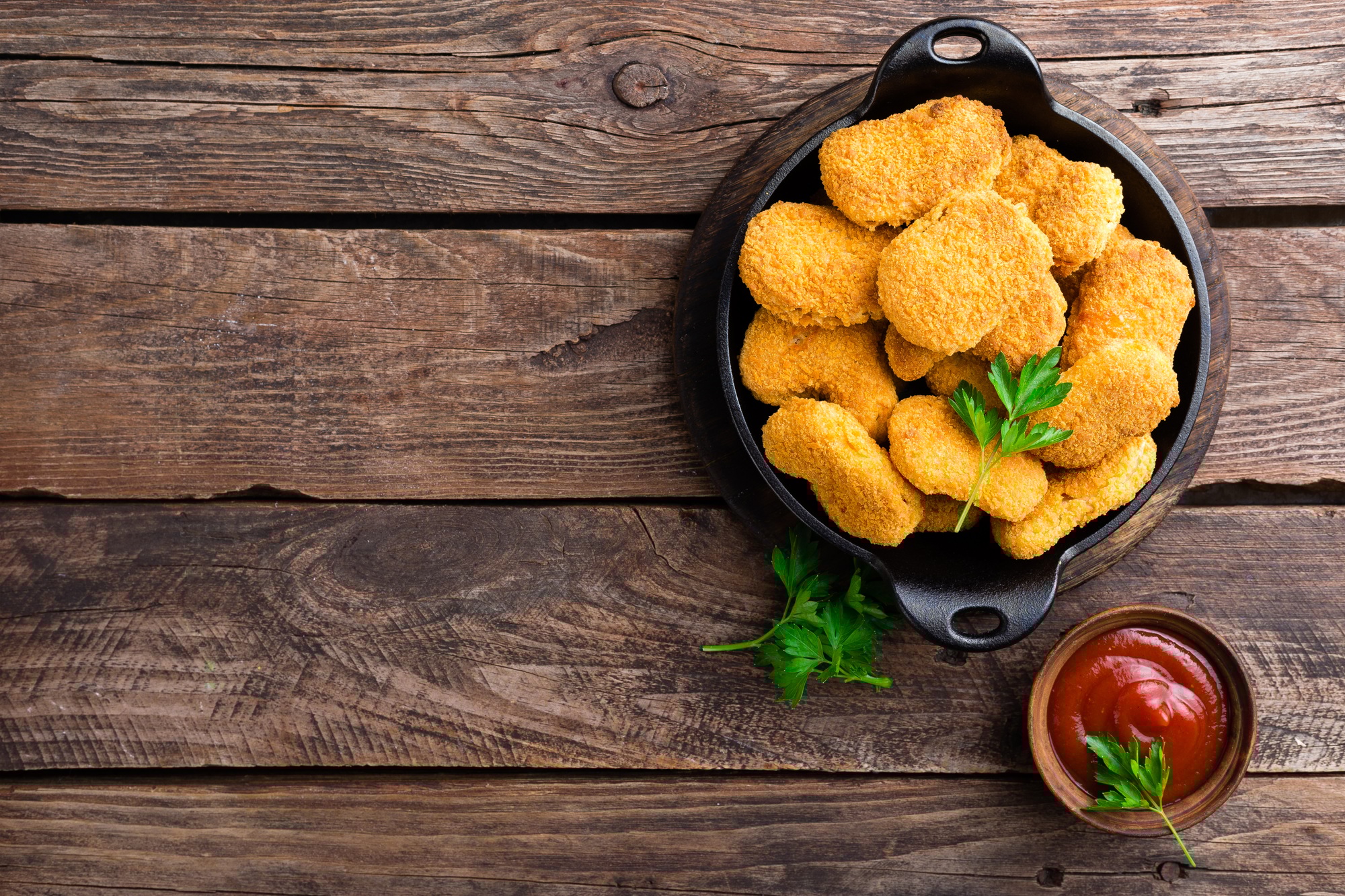 Nuggets. Chicken nuggets with ketchup on wooden table. Fast food